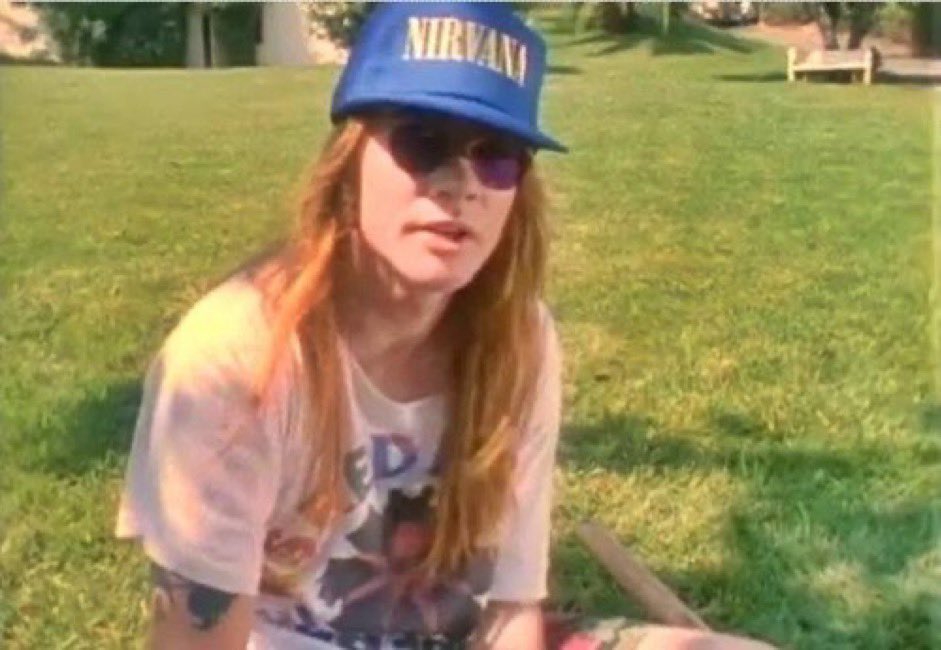Axl Rose wearing a Nirvana hat and Red Hot Chili Peppers shirt, 1990s.