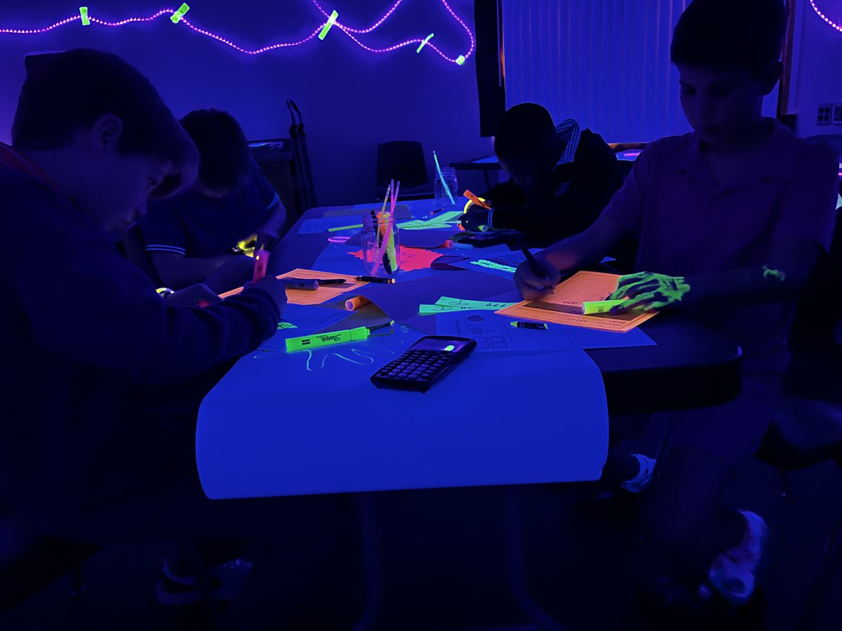 The middle school Explore Room was transformed into a blacklight math haven for a second year, and students loved the adventure. Sixth &amp; seventh grade students worked problems from stations, including fraction decimal percent, positive and negative slopes and more!