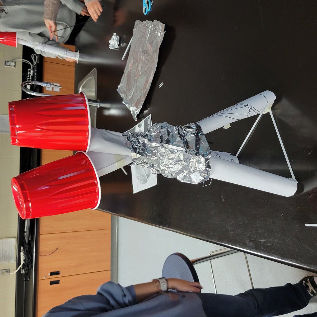 MsLoweClass's tweet photo. The challenge: Build a structure that can hold two cups as high and as far apart as possible using the listed materials. Then a 👍 discussion about our strategies for making sure our structures were both strong and stable. Such a fun class! https://t.co/Ka1RJoSsQO