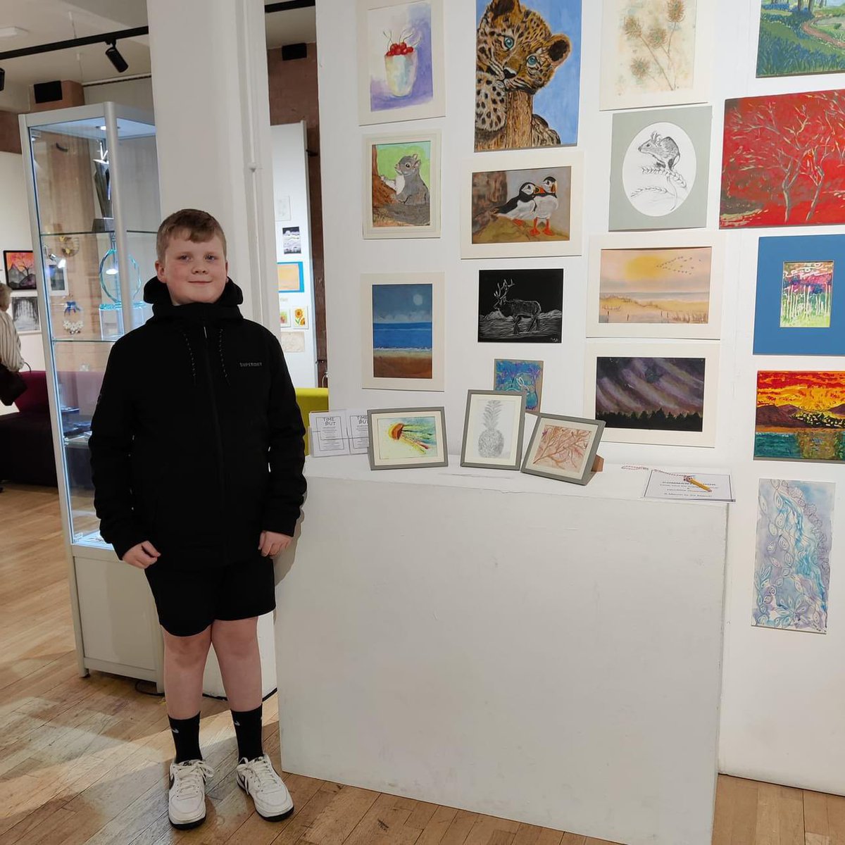 mojogo's tweet photo. @year6barwell Finlay L was very proud to see his nanna’s artwork on display at Atkins Building he took his too and it’s also on display with the Time Out Carers group.  @barwellacademy  3 framed pictures on the shelf. https://t.co/vlZiRfQe92