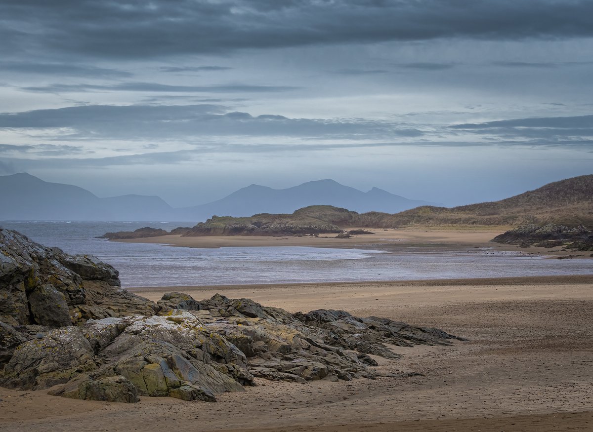 A simple very early morning view from the deserted beach across to Ynys Llanddwyn, Anglesey, with Yr Eifl in the background on the mainland 😊👍