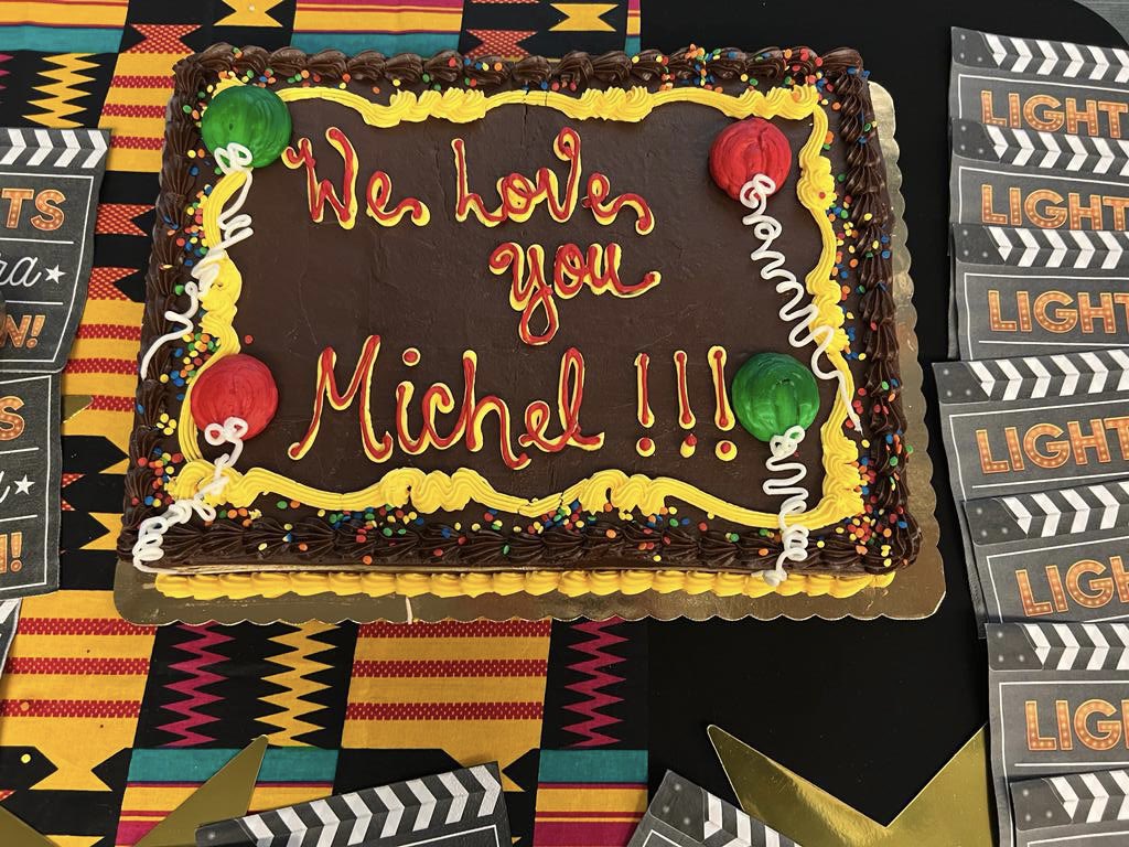 NPRinskeep's tweet photo. After her final weekend show, @NPRMichel posed with the @npratc staff and asked me to take the picture “because you have long arms.” Then the staff presented her with signed merch and a cake that, by all accounts, was heartfelt. She starts @MorningEdition in a few weeks. @NPR https://t.co/evfdA6k1Ux