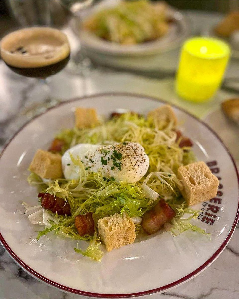 The Frisée Salad is true classic French bistro fare 🇫🇷 We use brioche croutons, bacon lardons, poached egg, and a bacon vinaigrette. As the French say... Parfait ! 👌