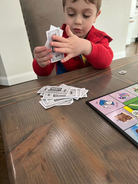 D31BeeHiveSI's tweet photo. Our little learner is showing off his #math skills while playing Monopoly Jr. #MarchMathChallenge #EarlyLearning @DrJoyAbrams @AP_JelaniMiller @DrMarionWilson @CSD31SI @NYCSchools https://t.co/AefqffJzxC