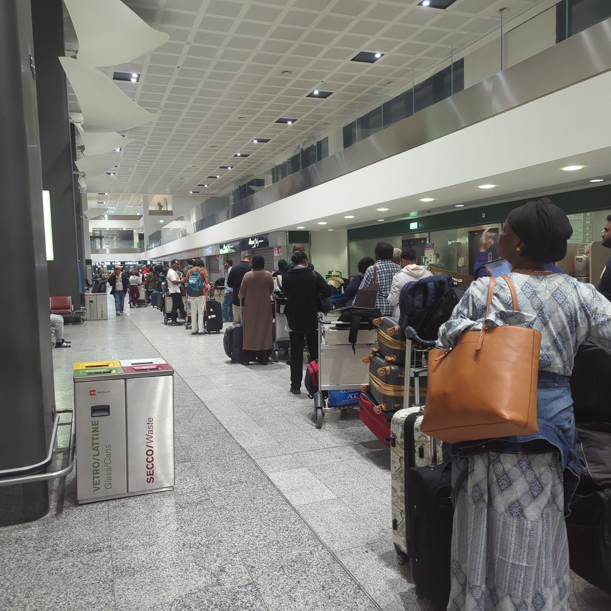pritamdodeja's tweet photo. @emirates @EmiratesSupport #poorservicealert - they turned our flight around halfway over the Atlantic. Understandable. Medical emergency. What is not understandable is staff nowhere to be found while people wait in line for accommodation. #dobetter #ek205 #stuckinmilan https://t.co/Gico4DiMeg