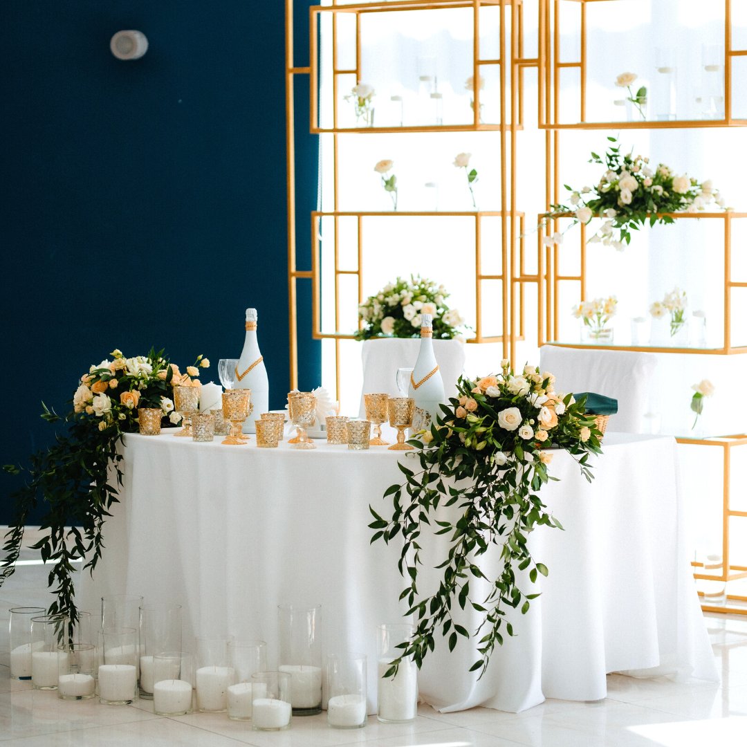 MaryBethBoehm's tweet photo. By using this metal bookshelf behind the sweetheart table, it frames and highlights the space.  By putting mini vases on different shelves, you create a really interesting look.  The flowers on the sides of the table,  instead of the middle, really frames out the space with a mod https://t.co/4jeTa6pbMk