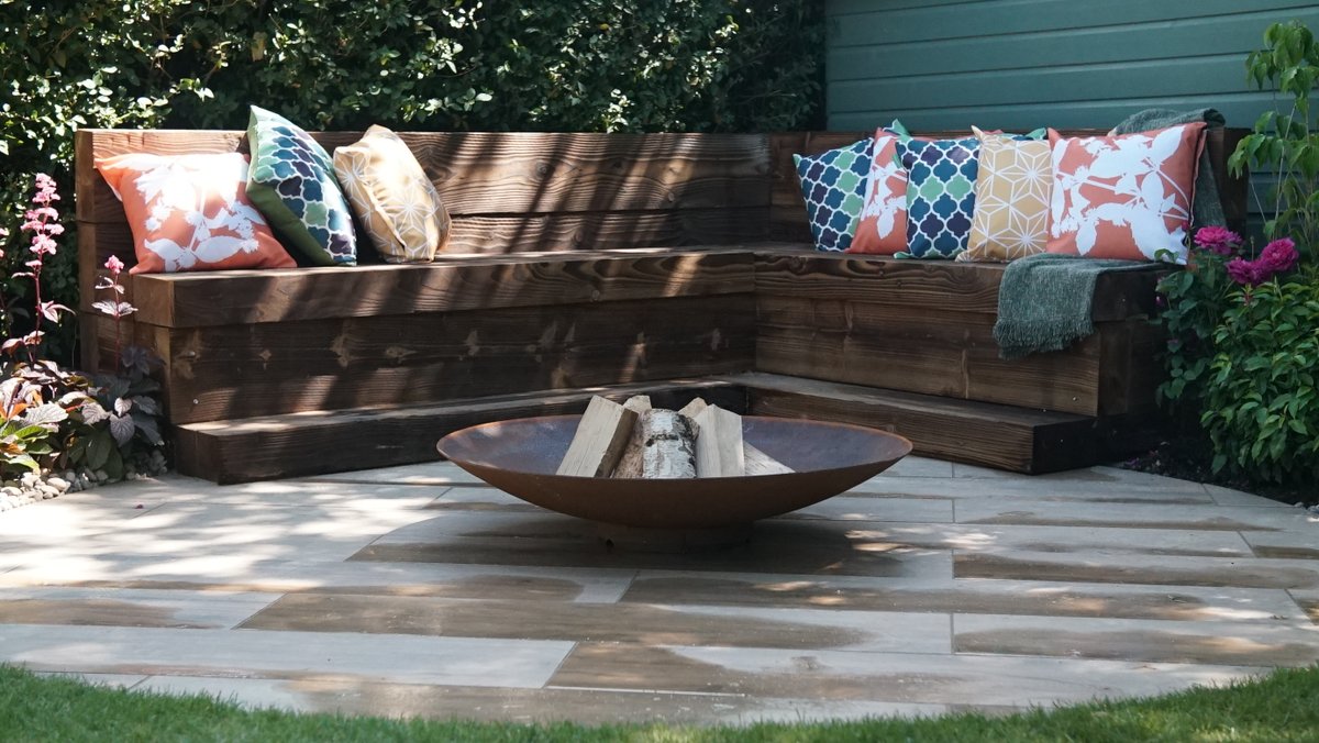 LoveYourGarden2's tweet photo. The seating area was created out of charcoal sleepers from BSW Timber 
Penny and Carl love the natural feel of their garden so this was the obvious choice. https://t.co/aOkciVryNM