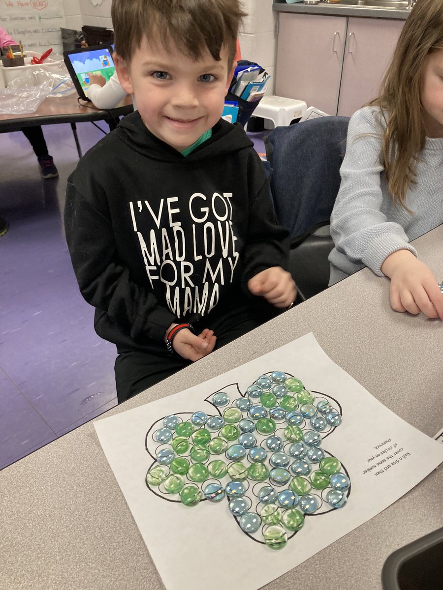Maria_KimeK's tweet photo. I’m lucky ☘️because I teach these amazing, creative kindergarteners! Our morning work this week has a St.Patrick’s Day theme. We are sorting lids to make a rainbow and rolling dice to build ☘️ shamrocks.  What can you build with repurposed lids?  @HeritageECS #HECSmagic https://t.co/L6EAUmoN6g