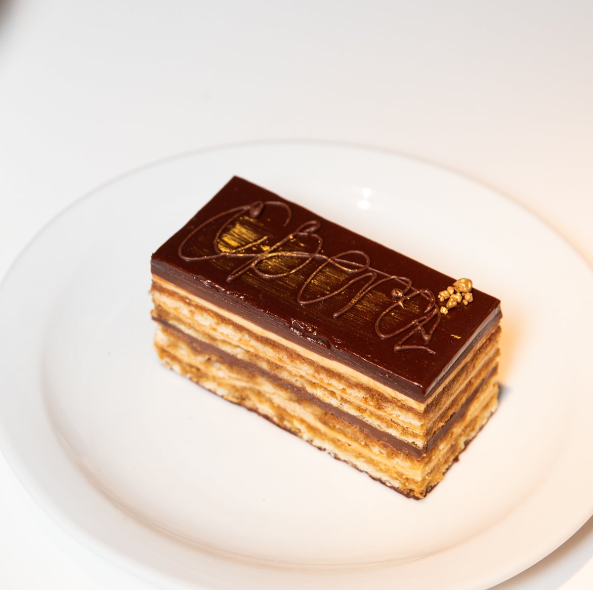 Are you a fan of Opera? You will be after trying our Opera Cake. Layers of almond sponge soaked in coffee syrup, layered with ganache and covered in a chocolate glaze! Ooh-la-la 🤤 #desserts #kensington #chelsea