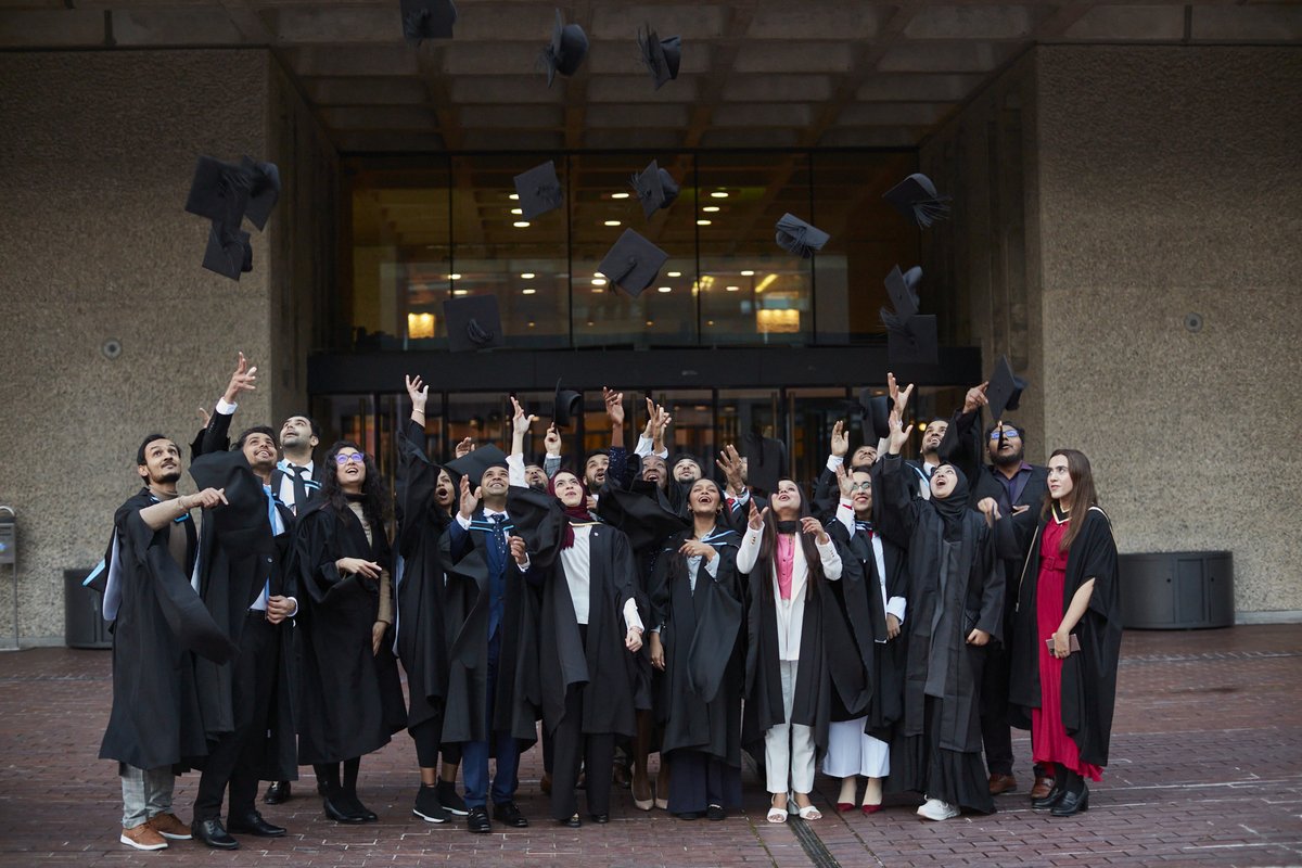 A selection of students throws their hats to celebrate graduation.