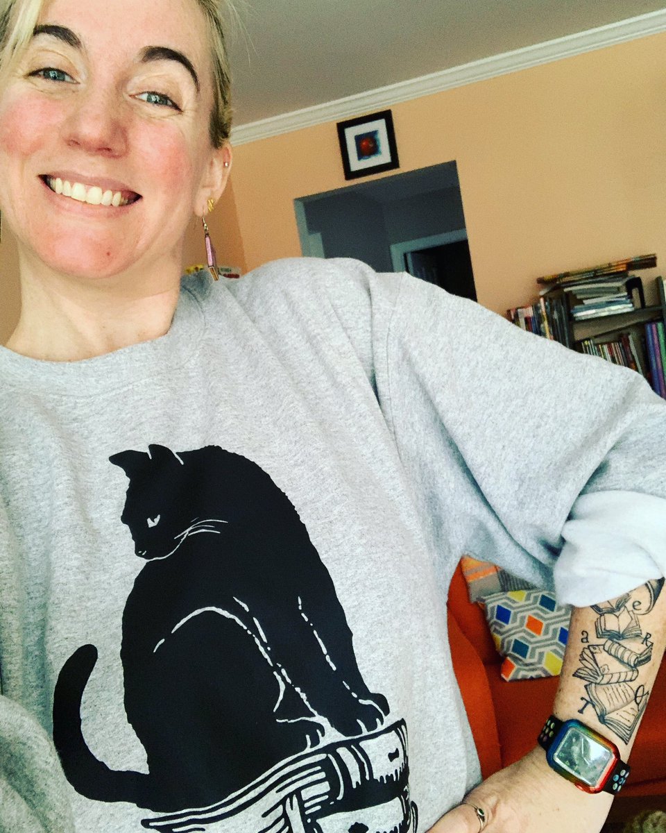 I’m not a “regular” mom. I’m a “cool tattooed librarian who pairs Little Women book earrings with oversized cats on books crew neck sweatshirts and rolls the sleeves to show off her new stack of books tattoo specifically to go read books to a group of 4-5 year olds” mom 😍😸❤️📚
