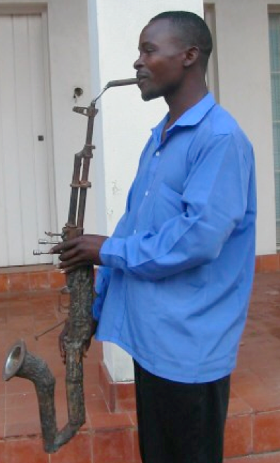 ShaneClaiborne's tweet photo. @philosophe42 Yep, it's happening. We have this photo in #BeatingGuns -- @mccpeace in Mozambique and Pedro Reyes made a fully orchestra from guns in Mexico. https://t.co/a46Z4fyAvO