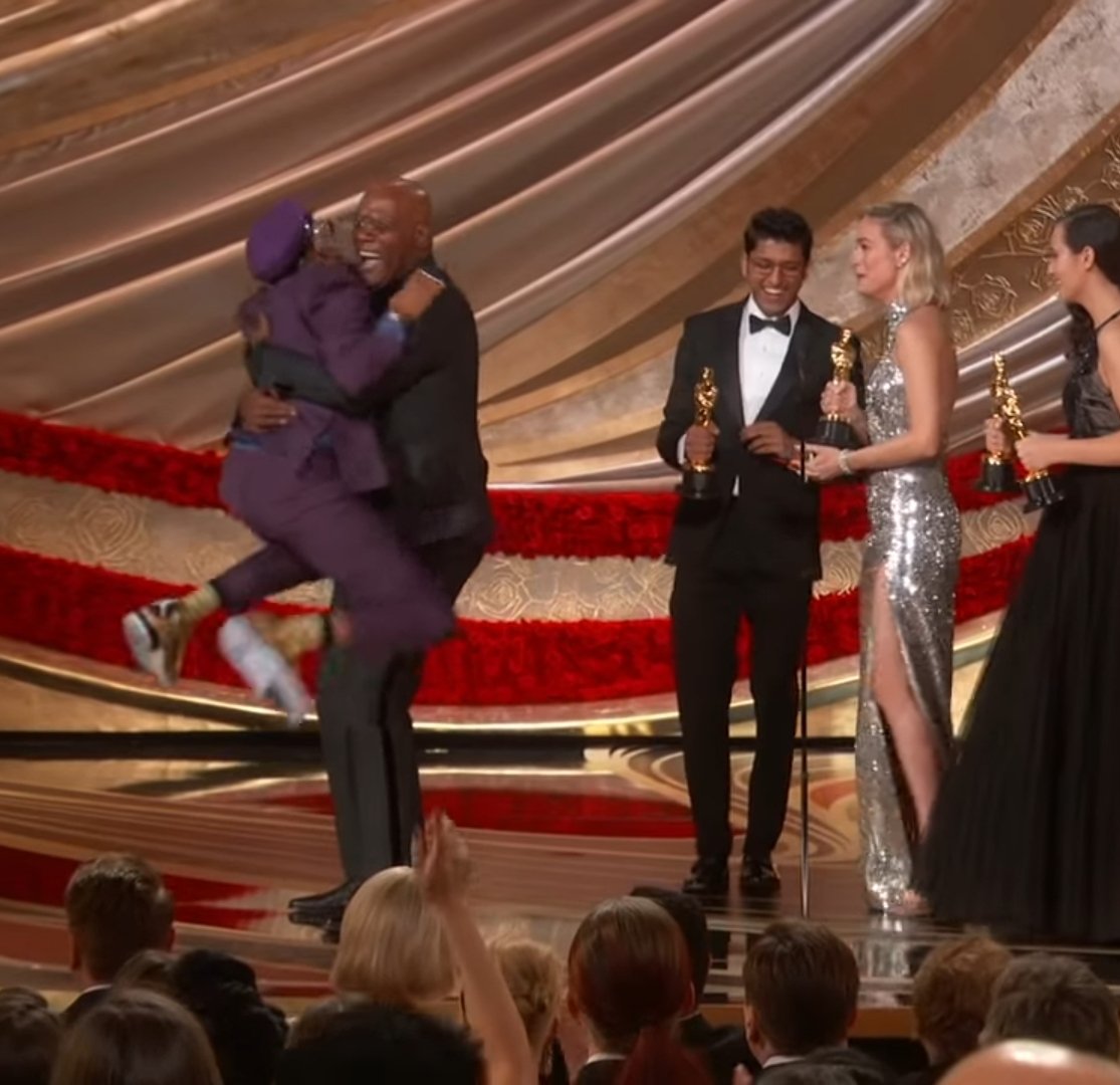 Spike Lee, dressed as waluigi, jumping into Samuel L. Jackson's arms after winning best adapted screenplay for Blackkklansman