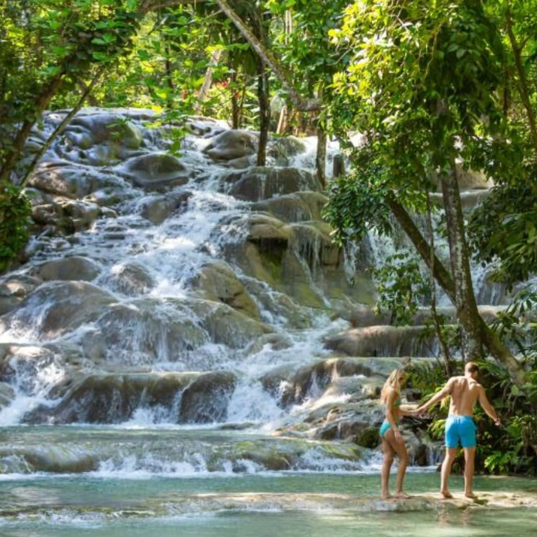 TravelByGeorgia's tweet photo. Venture to the famous Dunn's River Falls — a cascading waterfall that flows into the sea on the outskirts of Ocho Rios, Jamaica. The falls are gentle enough to climb, and you can swim in their natural pools. Contact us! https://t.co/emXuiZzIa6 https://t.co/UqizZsJsI1