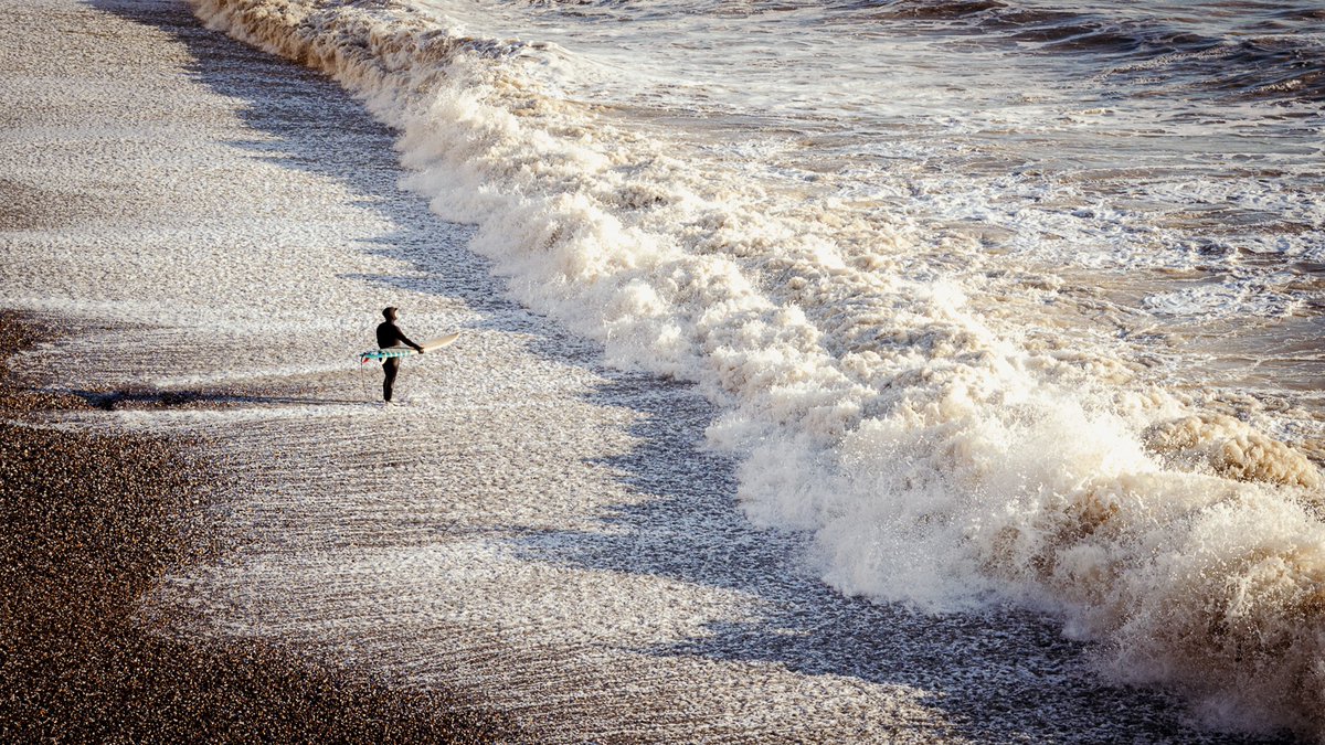 Man v Nature. A man prepares to go winter surfing at Birling Gap, West Sussex, UK in late winter sunshine today. #surfing #wintersurfing #birlinggap #nikonz6ii