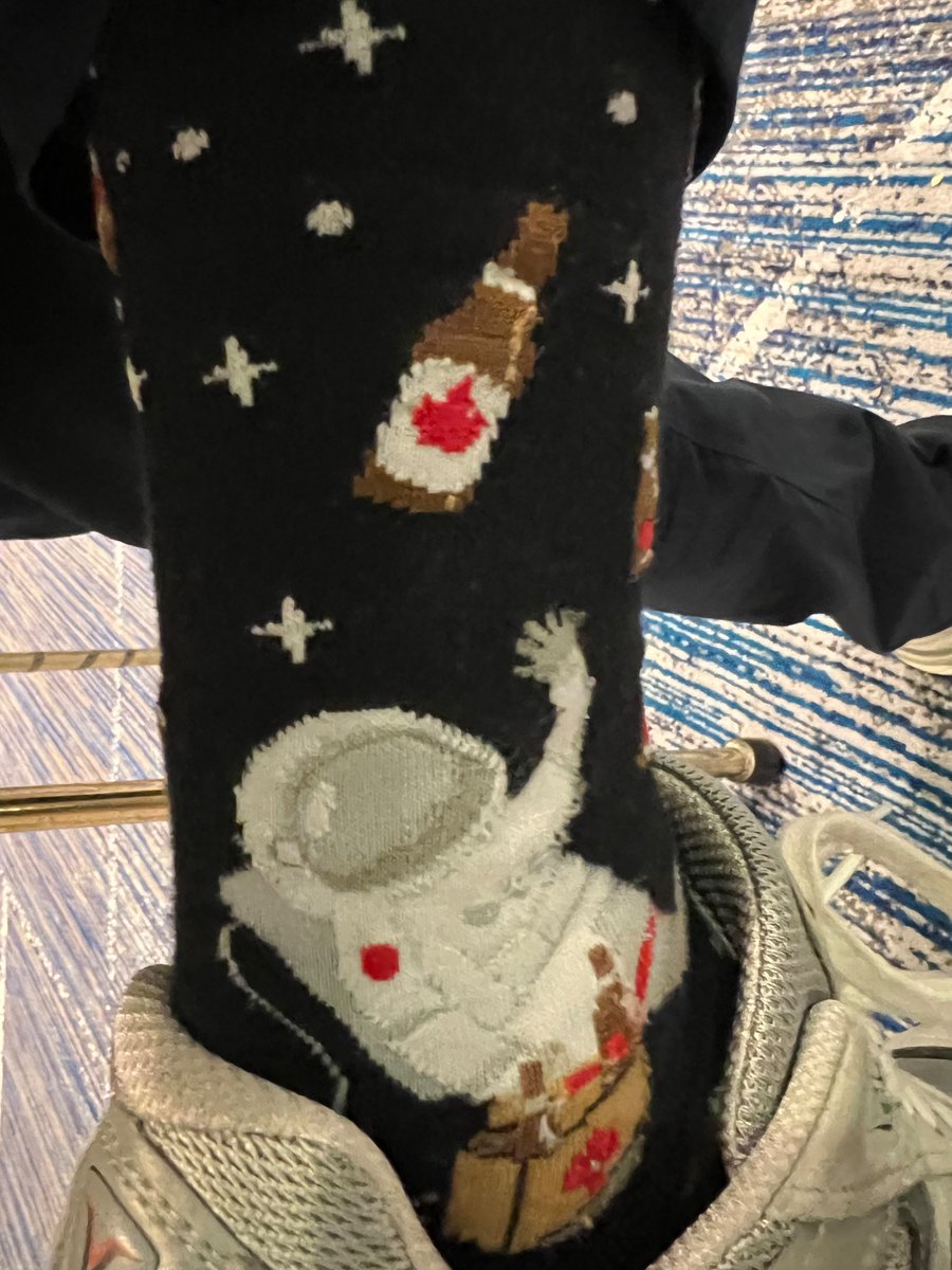 BenFeist's tweet photo. Canadian astronaut, on EVA, with Canadian beer, with poor tether discipline. An oddly specific and applicable #socksoflpsc #LPSC23 https://t.co/1usohYiGAb