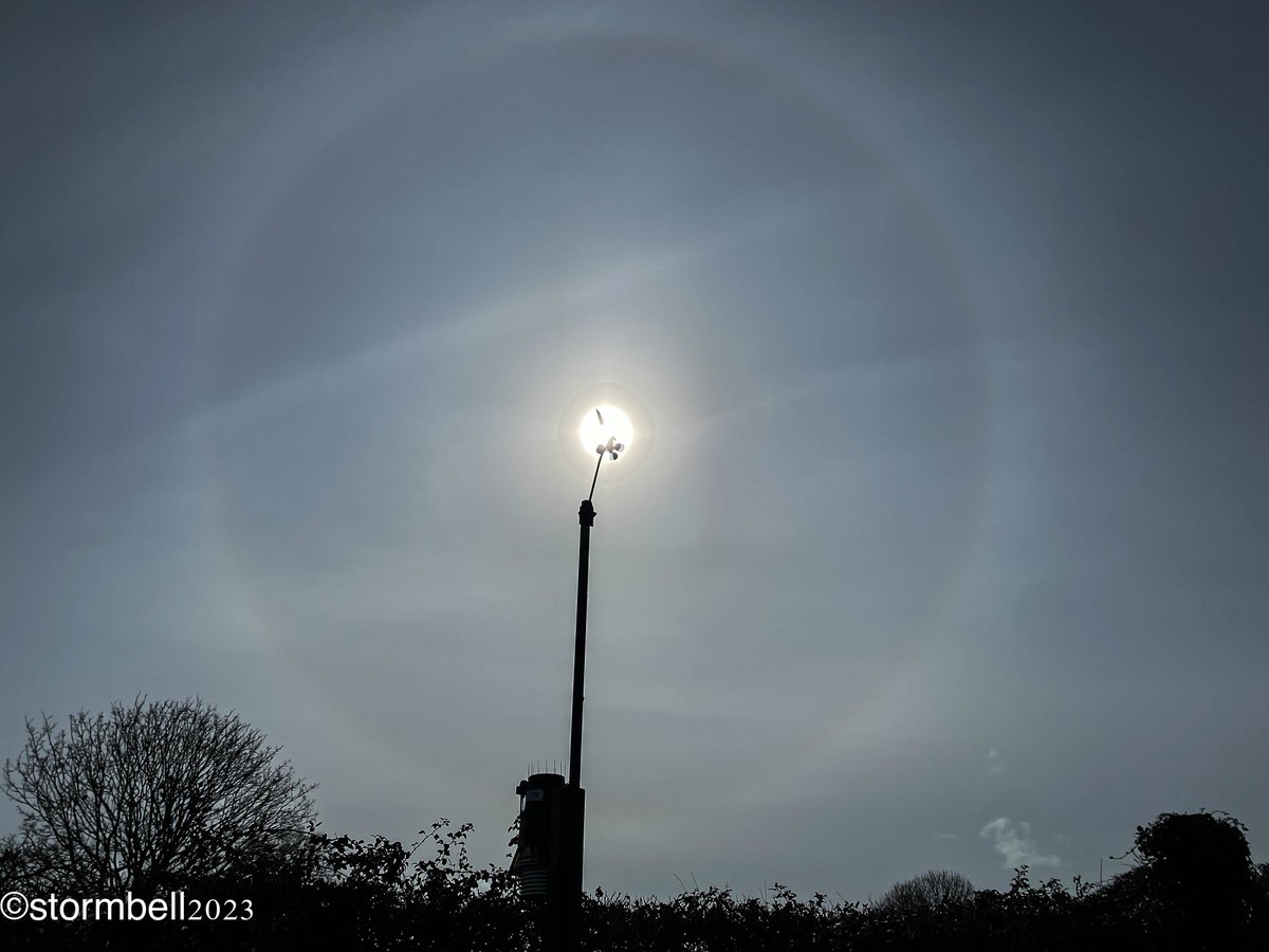 Classic approaching warm frontal sky with a thickening layer of cirrostratus produce a solar halo.