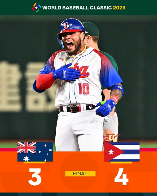 World Baseball Classic 2023 Quarterfinals:<br />
Final - Cuba 4, Australia 3.<br />
Pictured: Yoan Moncada pats the word CUBA across his chest after hitting a double. He wears a white Team Cuba uniform with red lettering and blue sleeves.