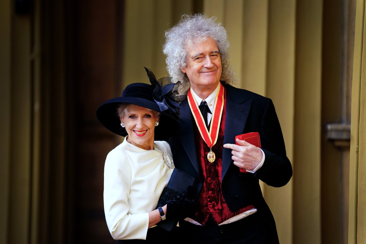 Sir Brian May @DrBrianMay poses with his wife Anita Dobson after being made a Knight Bachelor by King Charles III during an investiture ceremony at Buckingham Palace for services to music and charity. Picture date: Tuesday March 14, 2023. Picture credit: Victoria Jones/PA Wire
