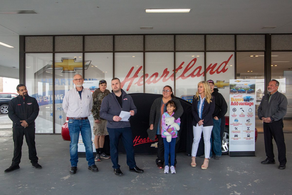 NKCSchools's tweet photo. Surprise! Johna Fox, a dedicated district parent, drove home today in a new car! Thanks to partners @HeartlandChevy_, @DiscountTire, &amp; @oreillyauto,  along with the hard work of our @CtecAutoTech, this @NKCFood employee has a safe vehicle for her family. https://t.co/8flo2AcFLD