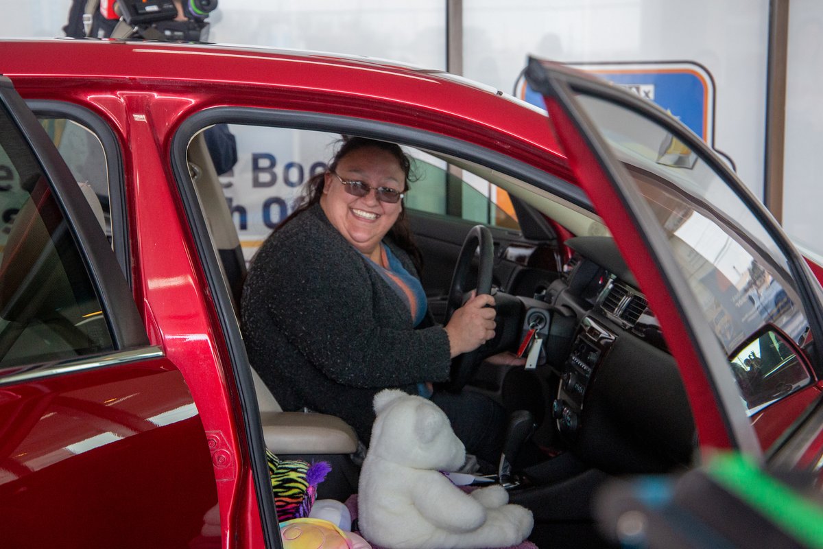 NKCSchools's tweet photo. Surprise! Johna Fox, a dedicated district parent, drove home today in a new car! Thanks to partners @HeartlandChevy_, @DiscountTire, &amp; @oreillyauto,  along with the hard work of our @CtecAutoTech, this @NKCFood employee has a safe vehicle for her family. https://t.co/8flo2AcFLD