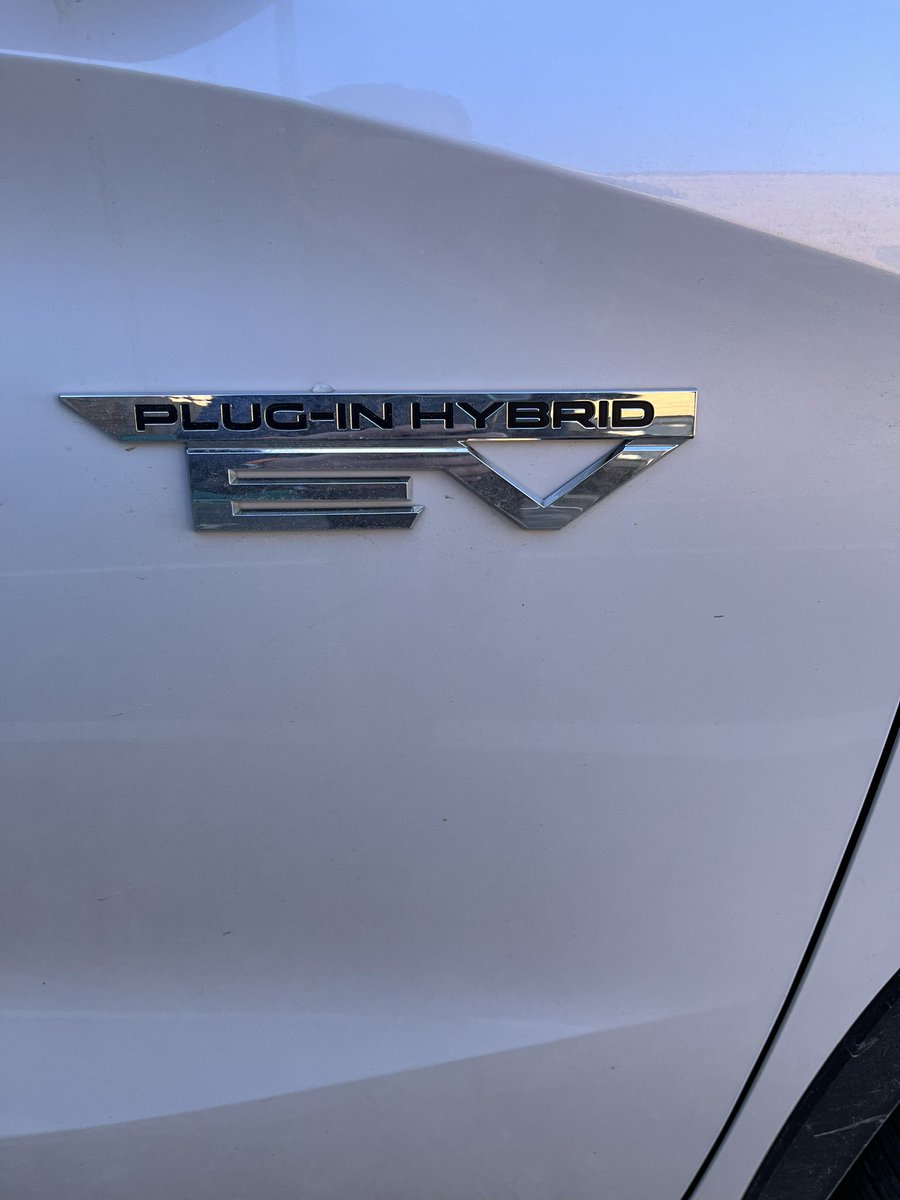 Never let the facts get in the way of a good (confusing, contradictory) badge, says the Mitsubishi Outlander PHEV