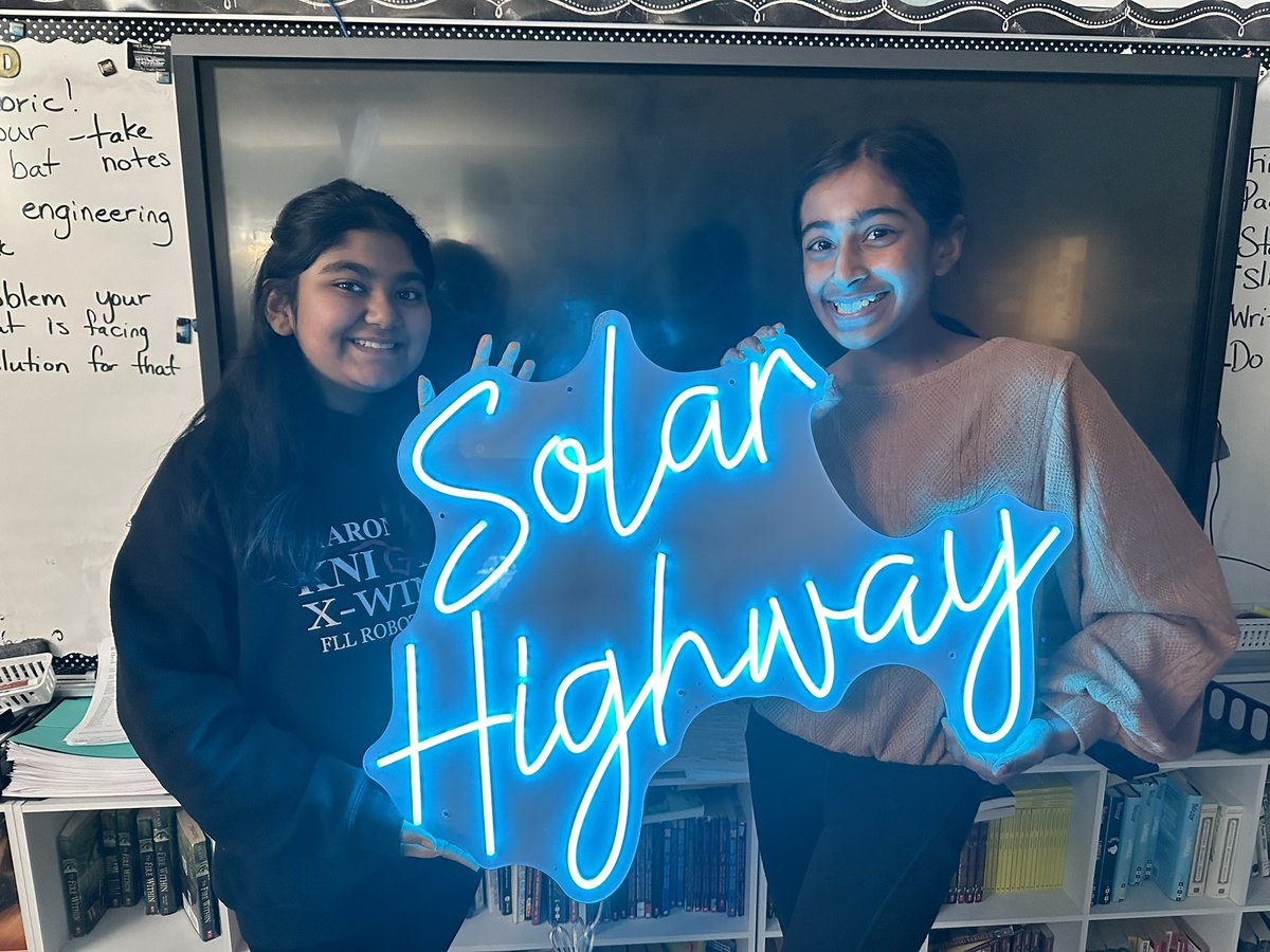 SRK26392's tweet photo. The Sharon Robo Knights love the neon sign that was donated to decorate our pit. #solarhighway Solving the problem of distributing energy to electric vehicles. Looking forward to meeting with our Tesla contact Zach Hill on Friday. @firstlegoleague @gafirstlego @Tesla @elonmusk https://t.co/xMPSkSiXnO