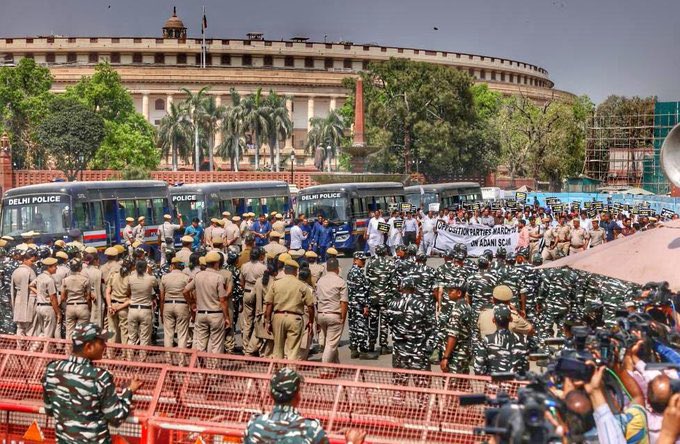 pbhushan1's tweet photo. Image of our democracy!No discussion of #Modani permitted in Parliament. When MPs of 18 parties try to march to ED office to register a complaint against Adani,2000 policemen in riot gear stop them.
But BJP says that @RahulGandhi must apologise for calling out State of Democracy! https://t.co/kYhjmm31Jm