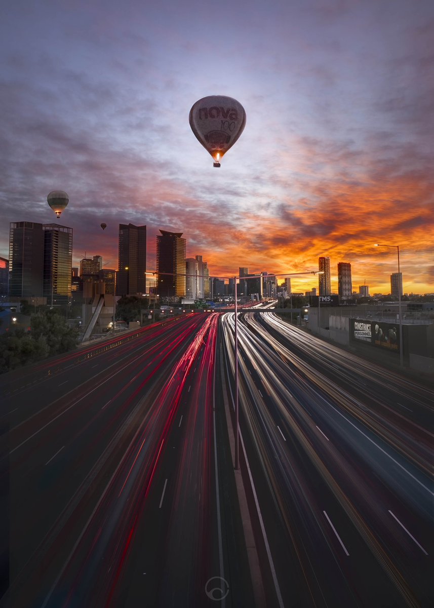 This morning’s sunrise. In Melbourne for a few days and decided to get up and take a shot.
Unexpected surprise balloon bonus…the one in the middle scared the hell out of me when it flew very low over my head and straight up the freeway. Pretty sure he was photo bombing me 😜