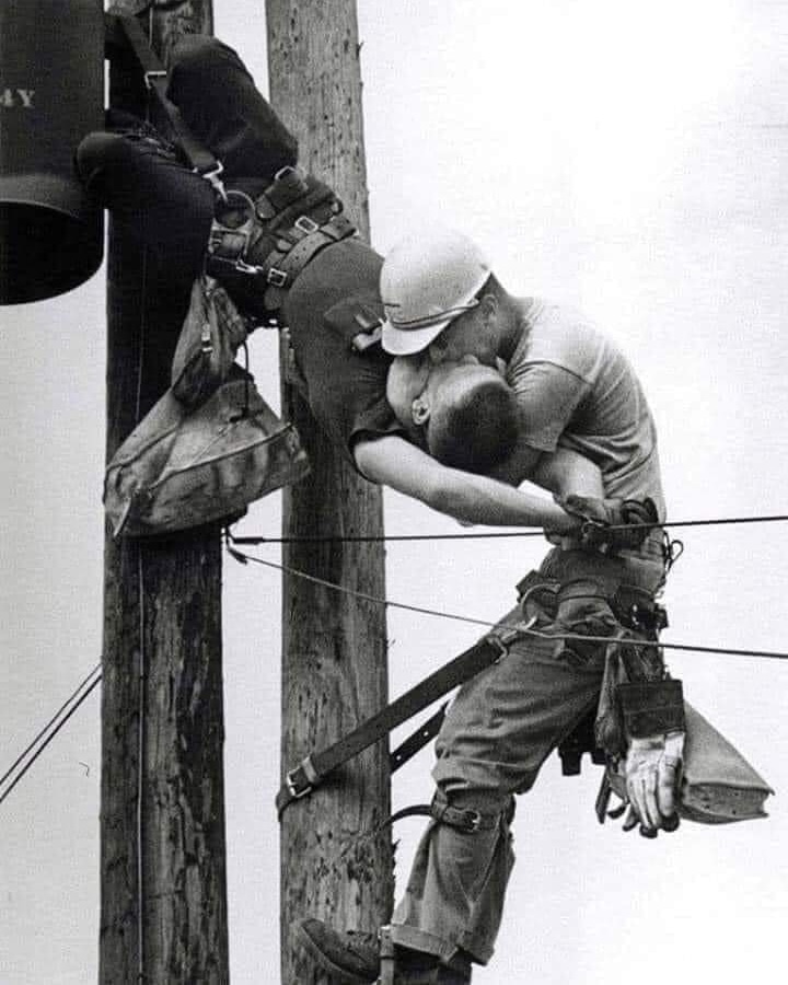KISS OF LIFE
The picture shows two electricians, Randall Champion and Jay Thompson, hanging from a power pole. 

Not only was he saved, thanks to Thompson, but he lived another 35 years. The electrician died in 2003 at the age of 64.
Thompson is alive today.