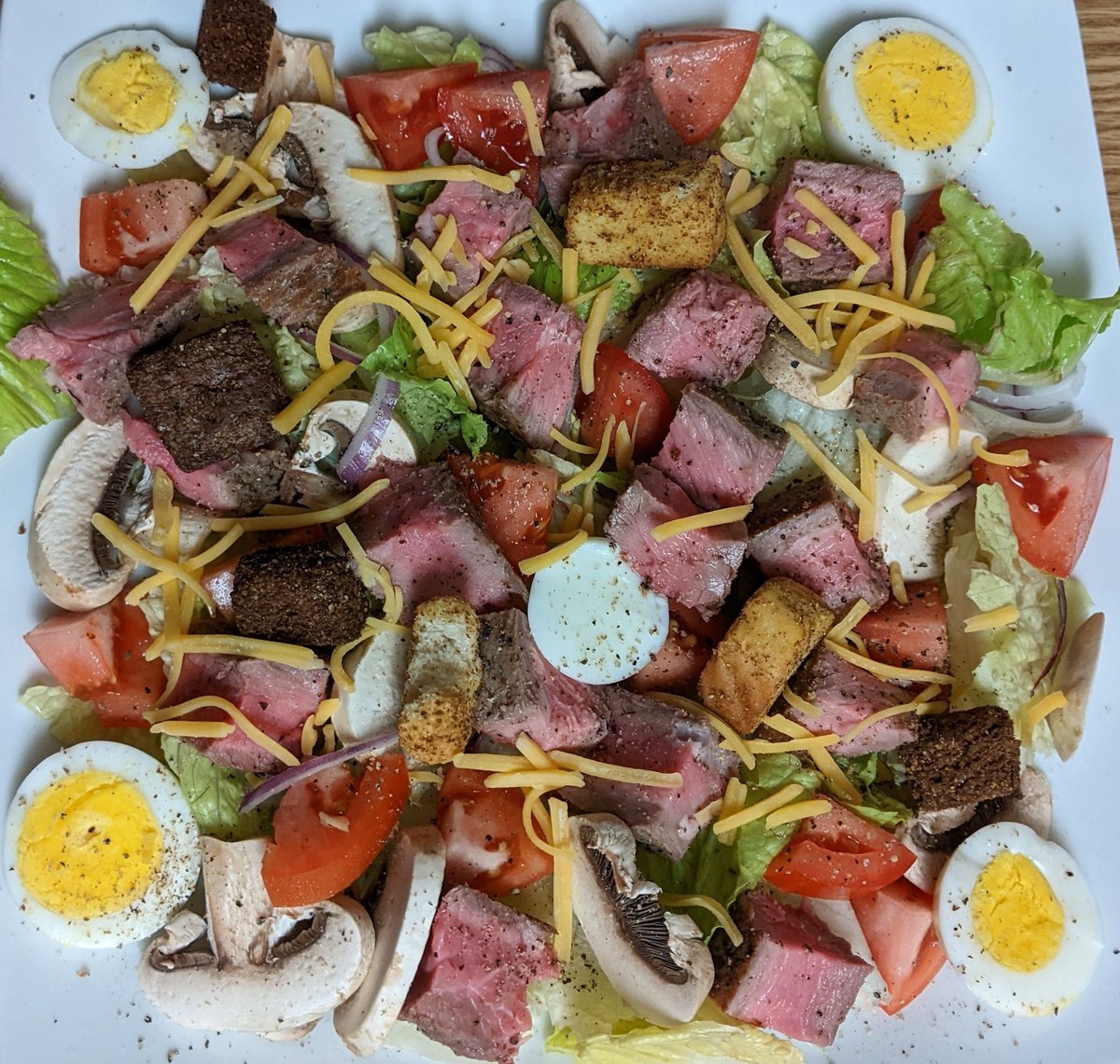 Steak Salad

#allkindsofrecipes #testkitchen #steaksalad #steak #salad #nystrip #newyorkstrip #romainelettuce #tomato #redonion #mushrooms #boiledegg #cheese #croutons #lunch