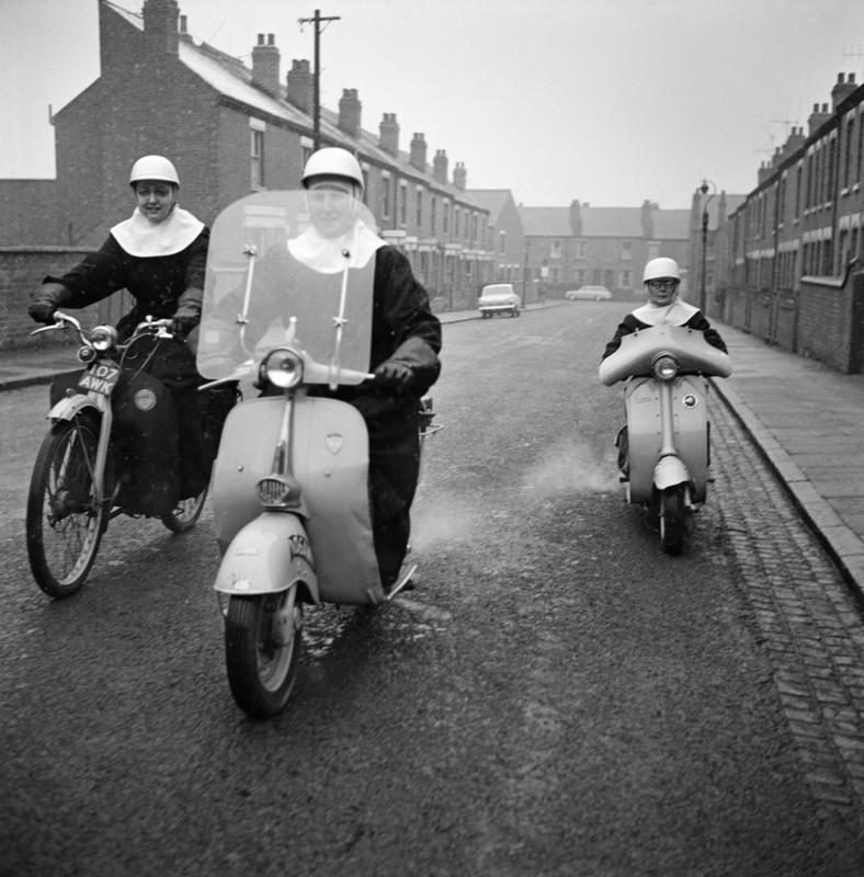 Daily Mirror photographer Tommy Lea out with The Angels', three nuns who live in the toughest district of Foleshill, Coventry. Who scoot around their city for fourteen hours every day helping, caring for and nursing anyone of any religion who needs help.  #archive