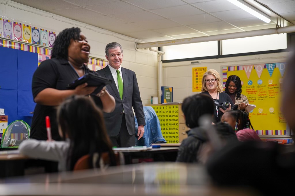 NC_Governor's tweet photo. We're working to ensure each student has access to the sound, basic education our constitution demands. Today, Gov. Cooper highlighted his proposed budget’s investments in education at Scurlock Elementary School in Hoke County, one of the original Leandro plaintiff districts. https://t.co/QmMUI46Dz6