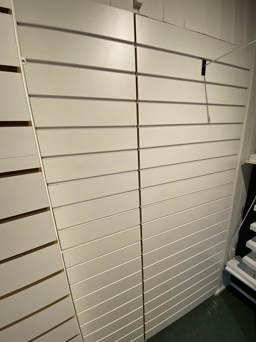Few sections of slat wall installed today, with hidden door behind for storage. #shopfitting
