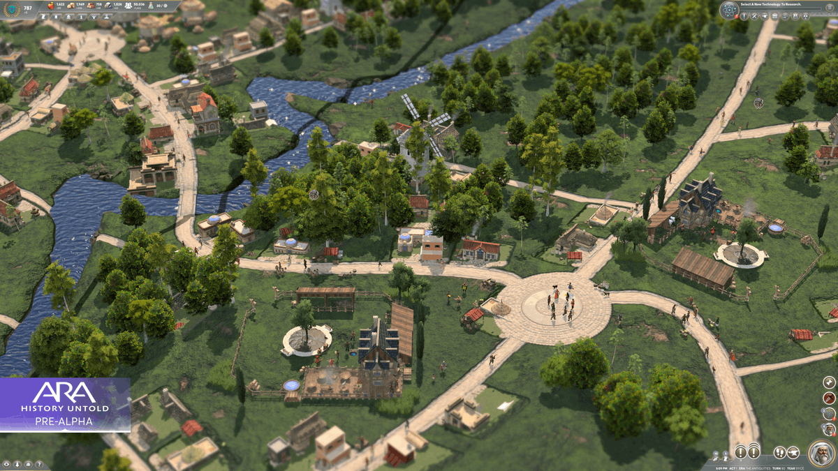 A screenshot from Ara: History Untold showing the zoomed-in living world of a city alongside a river, with stone roads, various buildings, and citizens performing tasks. In the bottom left corner, text reads: 