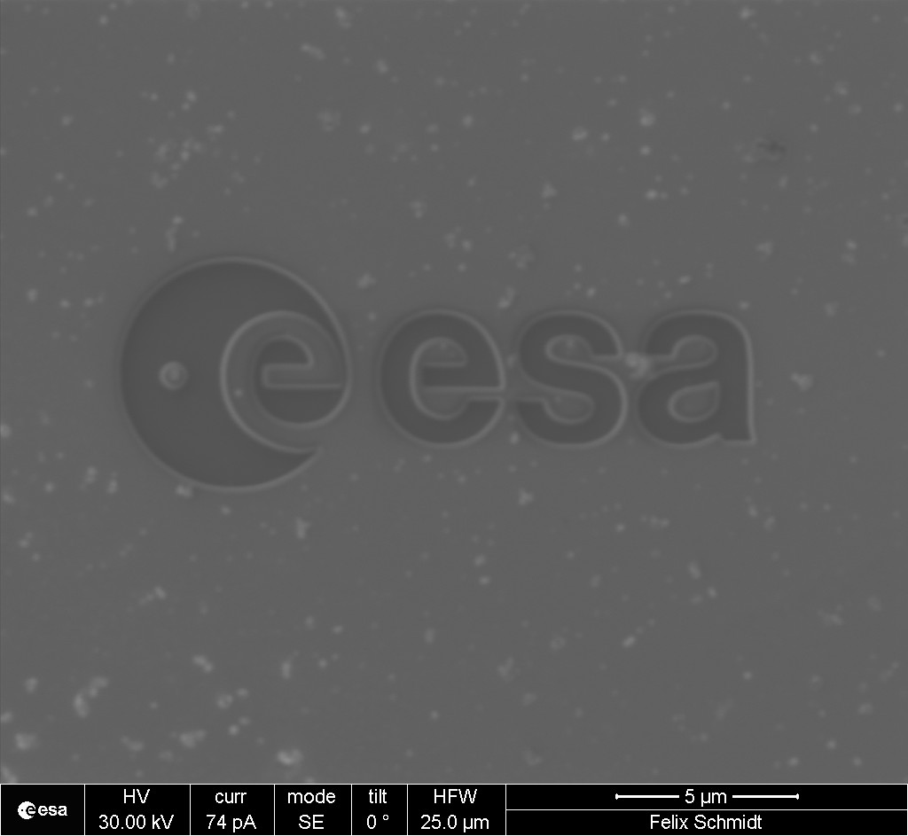 ESA_Tech's tweet image. This is an @ESA logo like no other - half the size of an human skin cell, just over 17 thousandths of a millimetre across. The #microscopic logo was carved from a space-grade nickel alloy with a plasma ion beam; see it beside a human hair, bottom right esa.int/ESA_Multimedia…