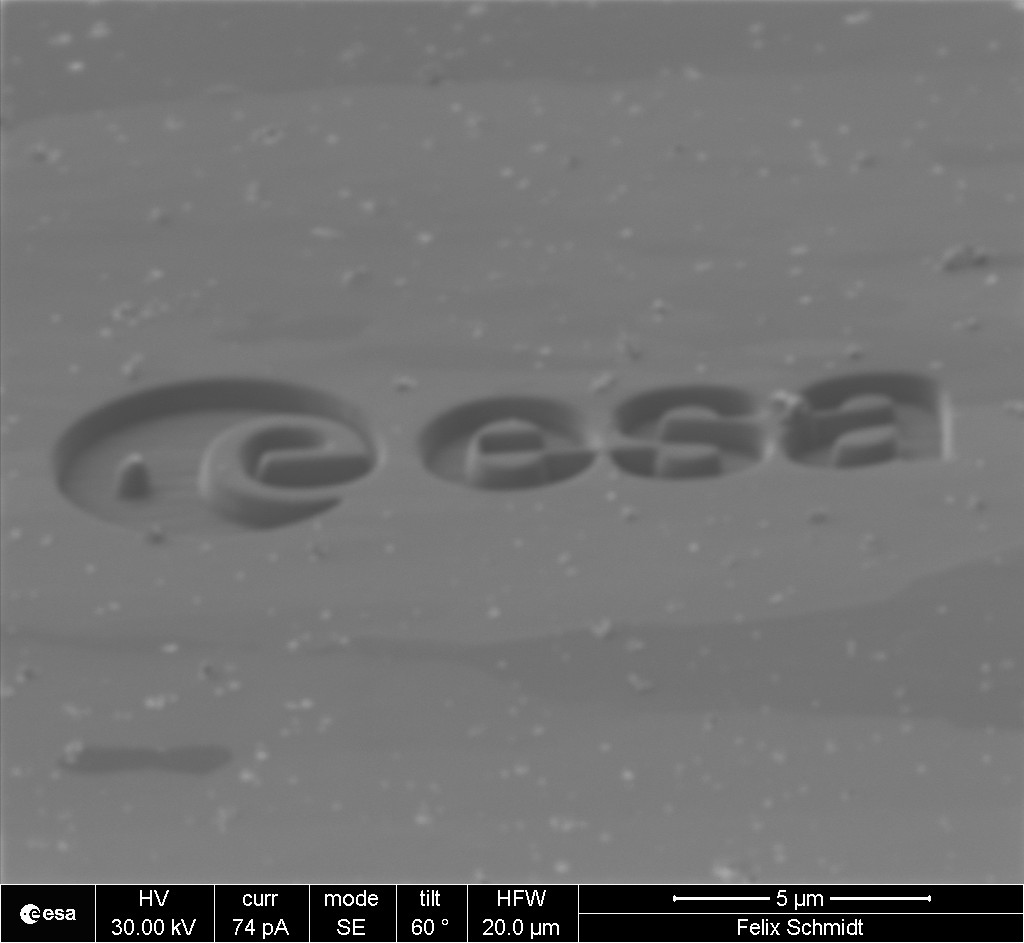 ESA_Tech's tweet image. This is an @ESA logo like no other - half the size of an human skin cell, just over 17 thousandths of a millimetre across. The #microscopic logo was carved from a space-grade nickel alloy with a plasma ion beam; see it beside a human hair, bottom right esa.int/ESA_Multimedia…