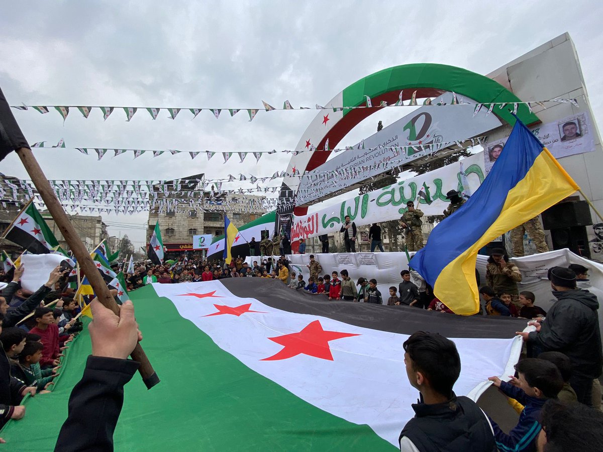 OzKaterji's tweet photo. It is so common to see the Ukrainian flag raised at demonstrations in Free Syria, a recognition of one shared struggle for liberty and democracy. https://t.co/8VLd3If6dG