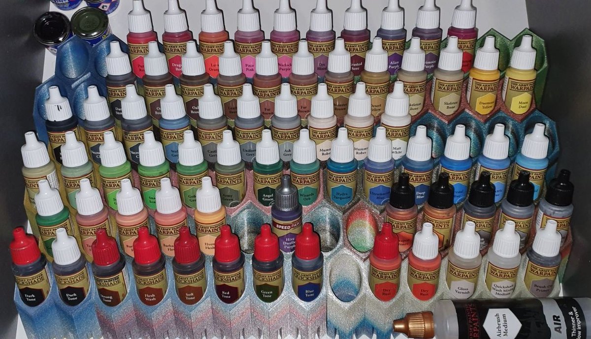 My husband asked for a storage system for his Army Painter bottles, which fits in a drawer and where he can see the color directly.

This is what we came up with:
Hexagonal, modular and angled bars you can slide together to create the perfect fit for every drawer. 😊