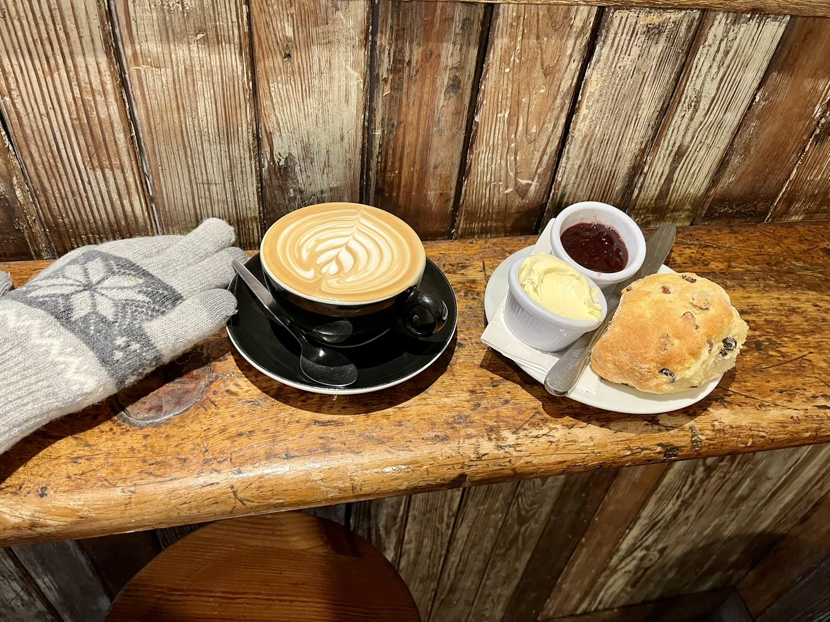 PhylFerrell's tweet photo. A scone with cream & jam and a flat white on my walk this morning? Why, yes! Happy St. Patrick’s Day! #Scotland #brainhealthweek https://t.co/WyJJK5JtLt