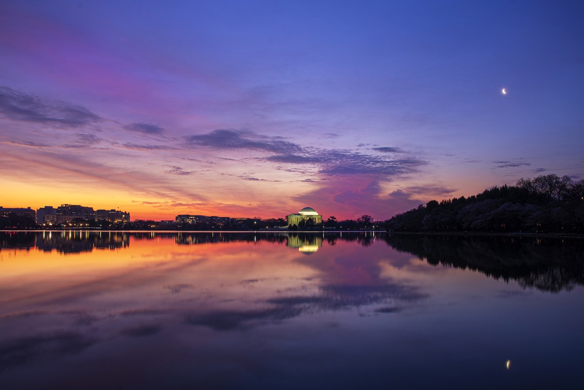 Sunrise and moonrise together this morning at the Tidal Basin. The water was glass smooth and created beautiful reflections of the sunrise colors and the crescent moon. <a href="/capitalweather/">Capital Weather Gang</a>