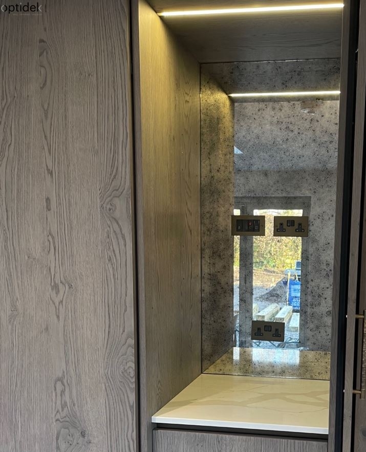 Antique mirror is a beautiful addition behind shelving and pocket doors providing the perception of depth whilst being entirely stunning. Installed here in Really Rough, we love how our glass compliments both the wooden tones in the cabinetry and luxurious worktop. #antiquemirror