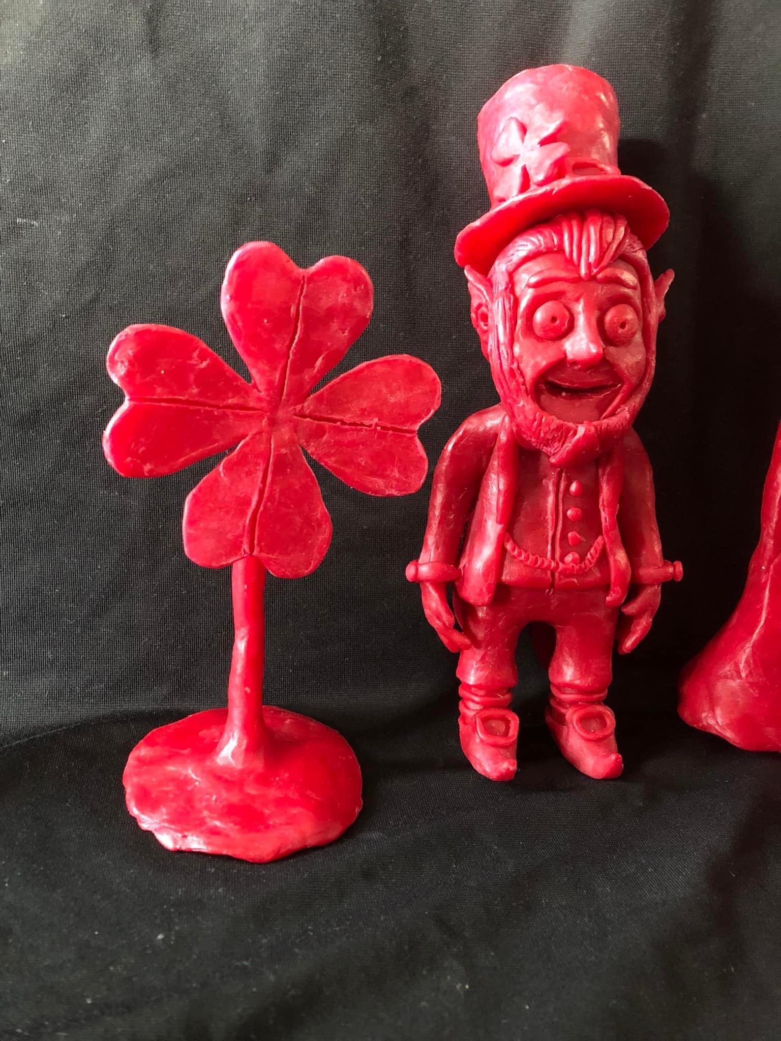 A shamrock and a leprechaun made from red Babybel cheese wax