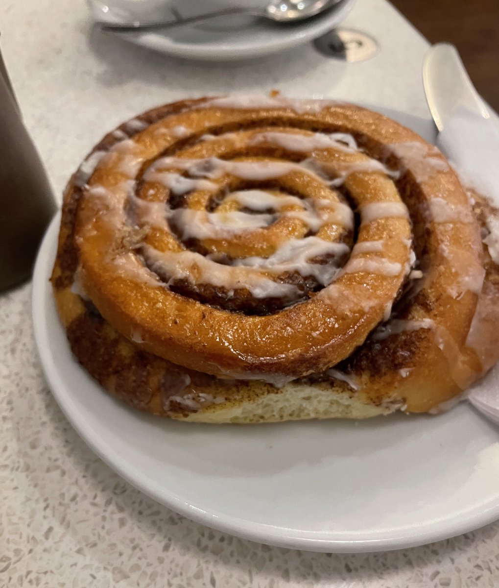 Springborn21's tweet image. Cinnamon bun the size of my face arrives but no sugar for my tea-being both pragmatic and unflappable, I quietly scrape the sugar icing off the bun and stir it into my tea. Sorted. Yes, you would be grateful I was there in a crisis actually. #SolutionsNotProblems