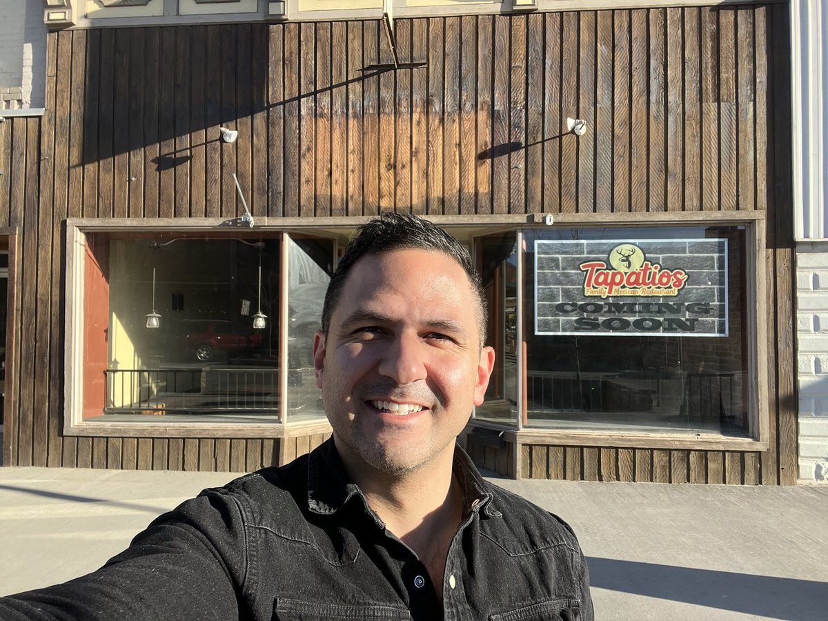 Shad standing in front of Tapatio’s, a restaurant with a western wooden front
