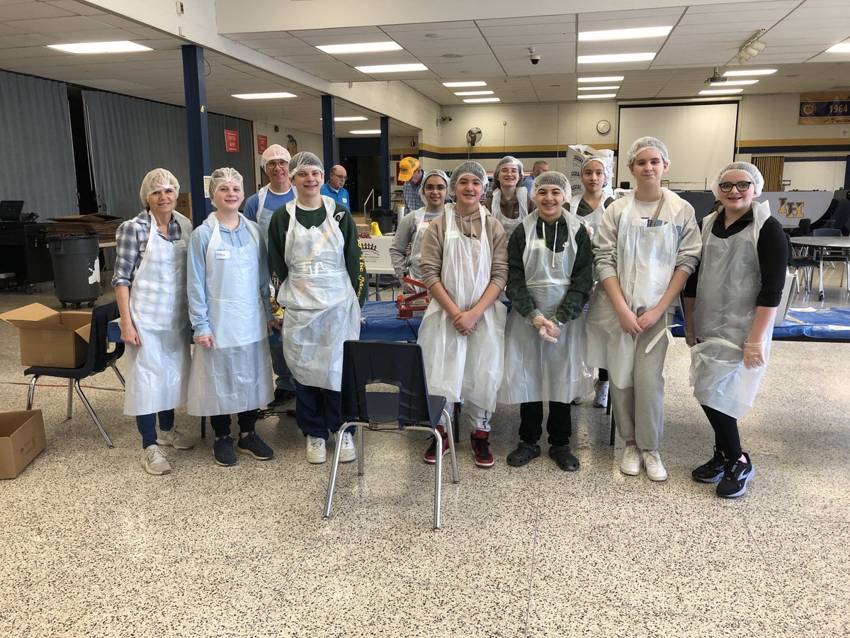 Eisenhower packing meals with Interact at Indian Hills High School for needy families.