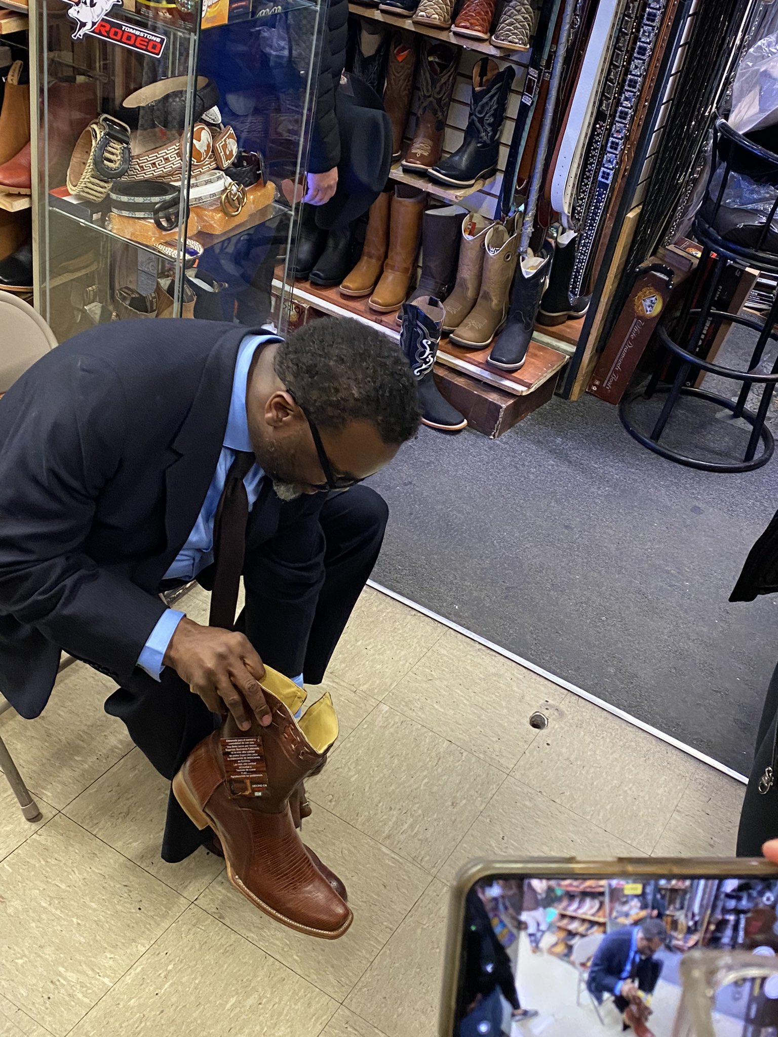 Alice Yin on X Johnson tries on a gift of boots at the Little Village discount mall Muy simpatico he exclaims after fitting them on. I really want to wear them now