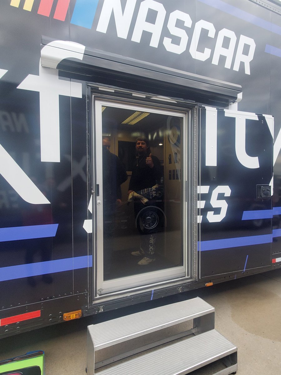 Josh Williams with the thumbs up as he waits inside the NASCAR hauler.