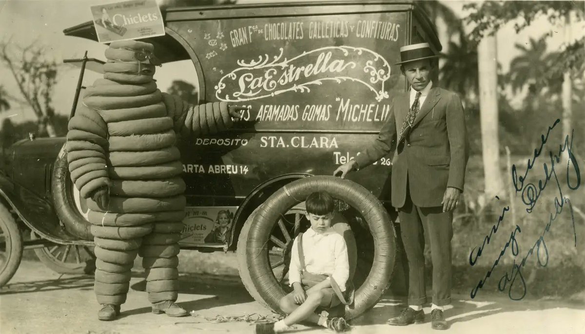 historydefined's tweet image. The Michelin Man poses with a scared child, 1926. See more: bit.ly/3RbBycF