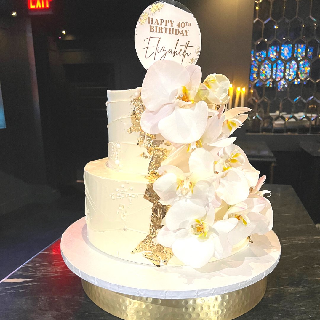 MaryBethBoehm's tweet photo. The most elegant birthday cake ever!  Thank you Steve at Sweeter Days Bake Shop for searching so hard to find the perfect real orchids for Elizabeth's birthday cake. And those touches of gold foil- Fabulous!  This cake was as elegant as the birthday girl! https://t.co/0q5ppRxTnt